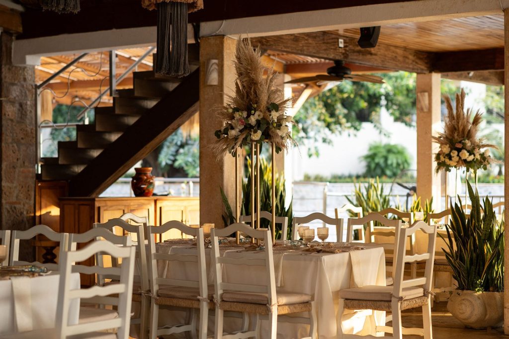 Wedding dinner tables under the palapa with garden view at Oscar's Puerto Vallarta