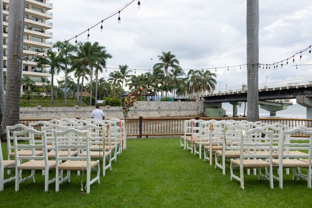 Garden wedding ceremony setup with river and palm views at Oscar's Puerto Vallarta