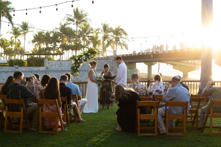 Garden wedding ceremony at sunset with string lights and palm trees at Oscar's in Puerto Vallarta