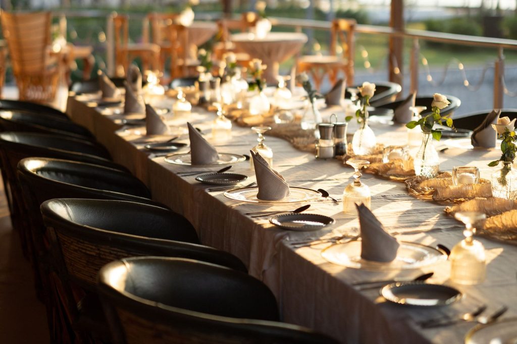 Long dinner table at sunset by the river at Oscar's restaurant in Puerto Vallarta