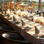 Long dinner table at sunset by the river at Oscar's restaurant in Puerto Vallarta